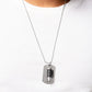 Paparazzi Accessories - Proud Patriot - Black Urban Necklace pinched between a black leather fitting, a silver bullet pendant joins a silver dog tag at the bottom of a silver ball chain. The shimmery dog tag is stamped in the phrase, "Because of the Brave," for a patriotic finish. Features a ball and clasp closure.  Sold as one individual necklace.