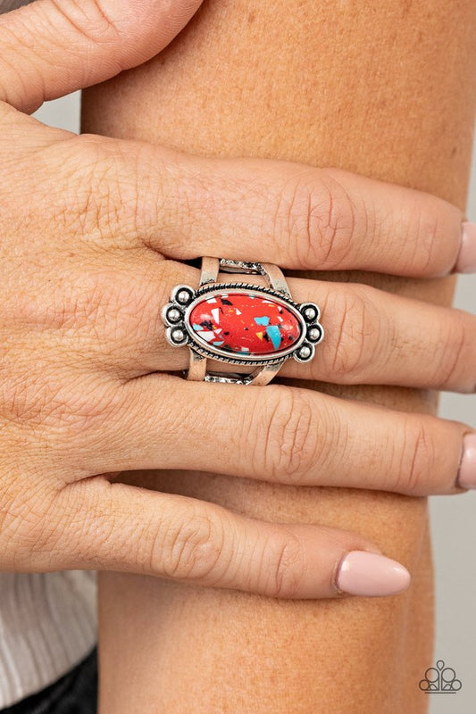 Paparazzi Accessories - Psychedelic Deserts - Red Rings featuring a faux marble finish, an elongated oval speckled red stone is pressed into the center of a textured silver frame dotted with antiqued silver studs, creating a tranquil centerpiece atop the finger. Features a stretchy band for a flexible fit.