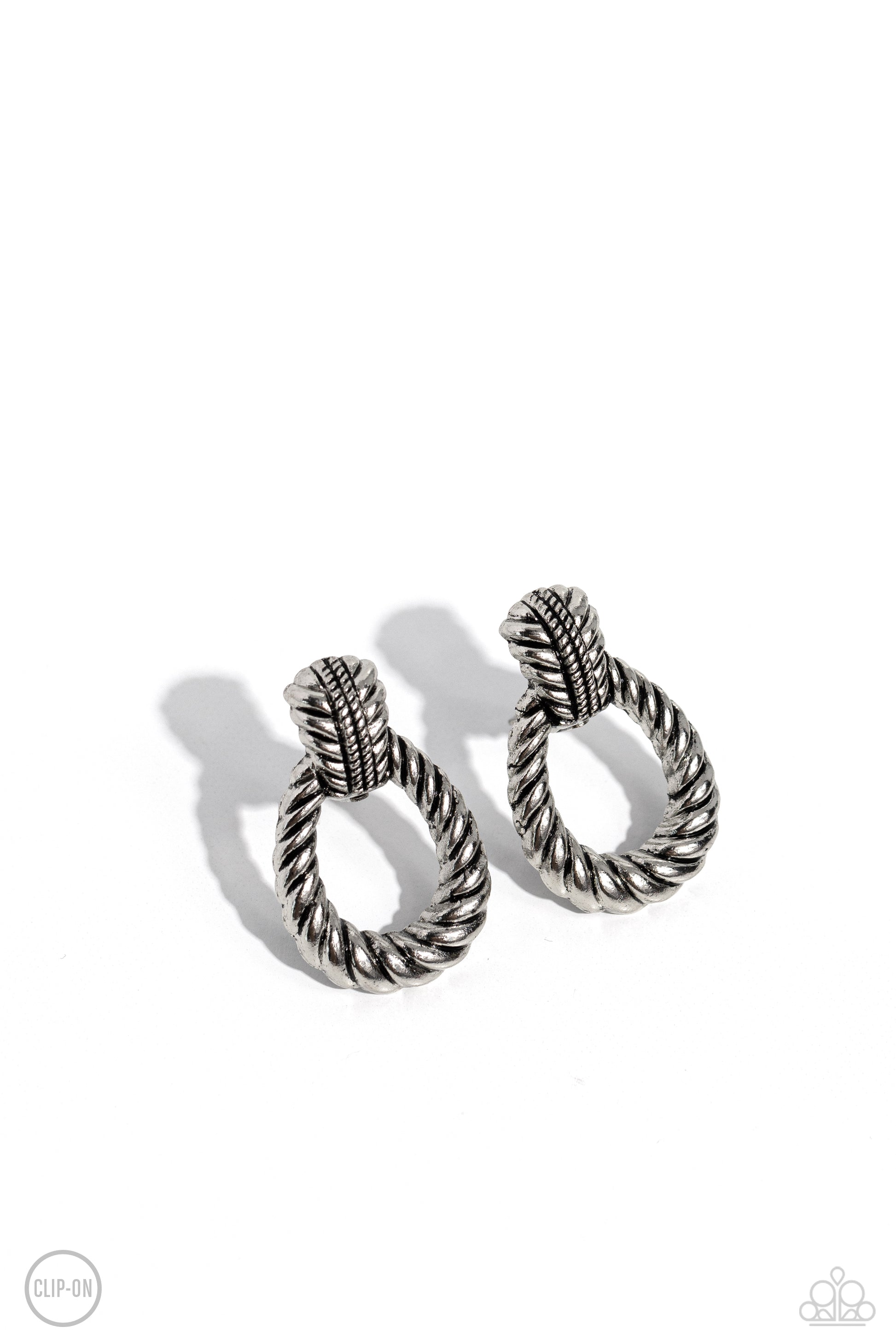 Paparazzi Accessories - Roping Rodeo - Silver Clip-On Earrings featuring twisted ropelike texture, an antiqued loop attaches to a studded silver fitting for a rustic flair. Earring attaches to a standard clip-on fitting.  Sold as one pair of clip-on earrings.