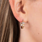 Paparazzi Accessories - Starfish Showpiece - Gold Hoop Earrings a shiny gold bar curls around the ear into a dainty hoop. Three gold stars gradually increase in size as they climb the curve of the hoop, with the biggest star emblazoned with iridescent crystal-like rhinestones across its surface. Earring attaches to a standard post fitting. Hoop measures approximately 1/2" in diameter. Due to its prismatic palette, color may vary.  Sold as one pair of hoop earrings.
