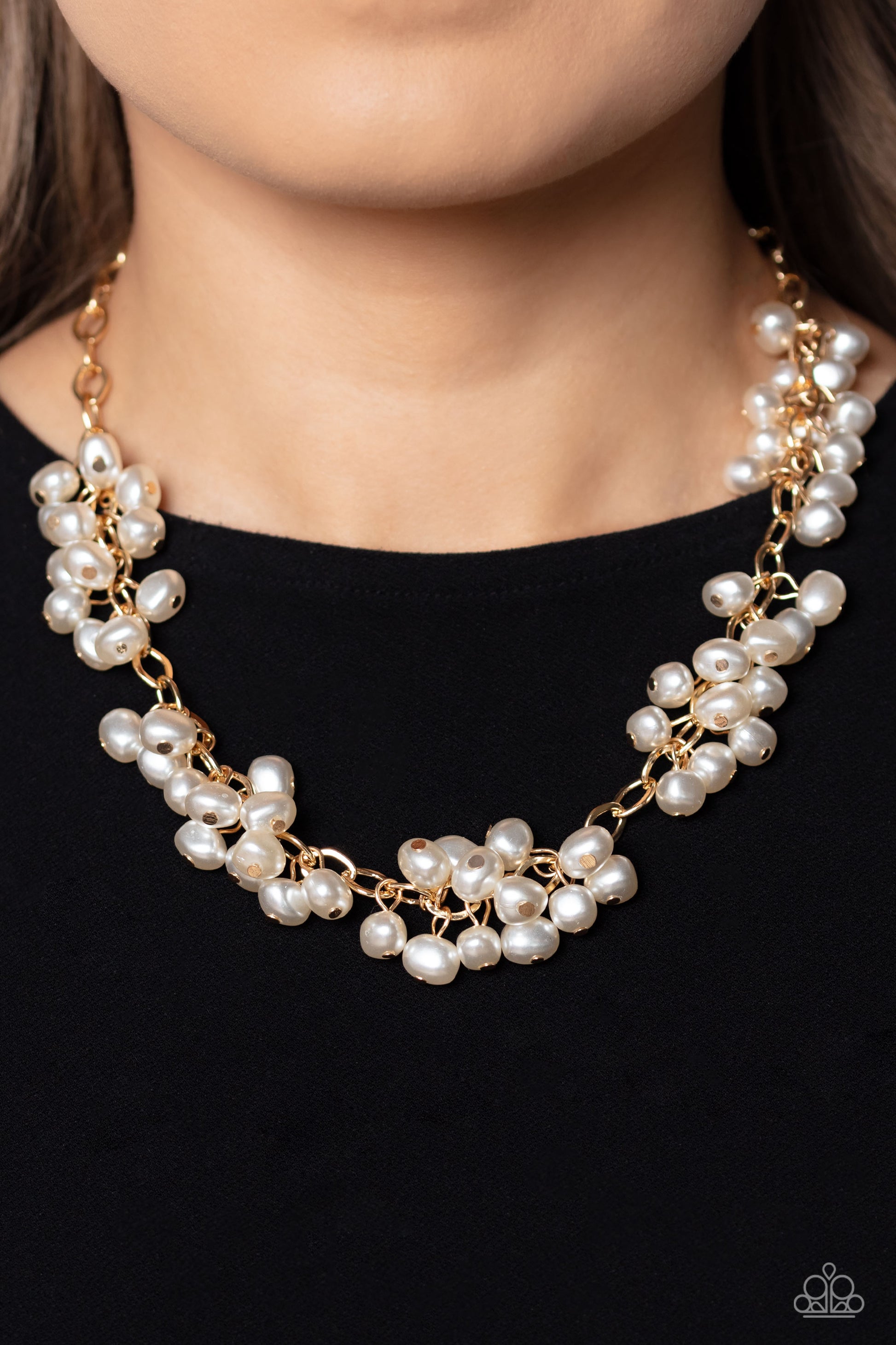 Paparazzi Accessories - Pearl Parlor - Gold Pearl Necklaces a cascade of classic white pearly beads dangle from a high-sheen gold, oval linked chain. The pearly beads cluster across the neckline, creating a refined pop of color. Features an adjustable clasp closure.  Sold as one individual necklace. Includes one pair of matching earrings.
