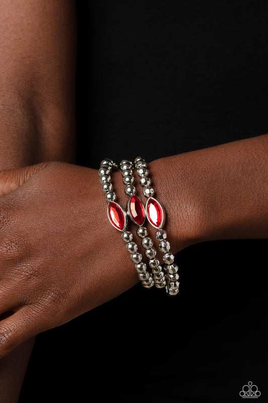 Paparazzi Accessories - Twinkling Team - Red Bracelets featured in the center of a faceted and smooth silver beaded display, a dazzling red, marquise-cut gem pressed in a sleek silver frame wraps around the wrist on elastic stretchy bands for a classy statement.  Sold as one set of three bracelets.