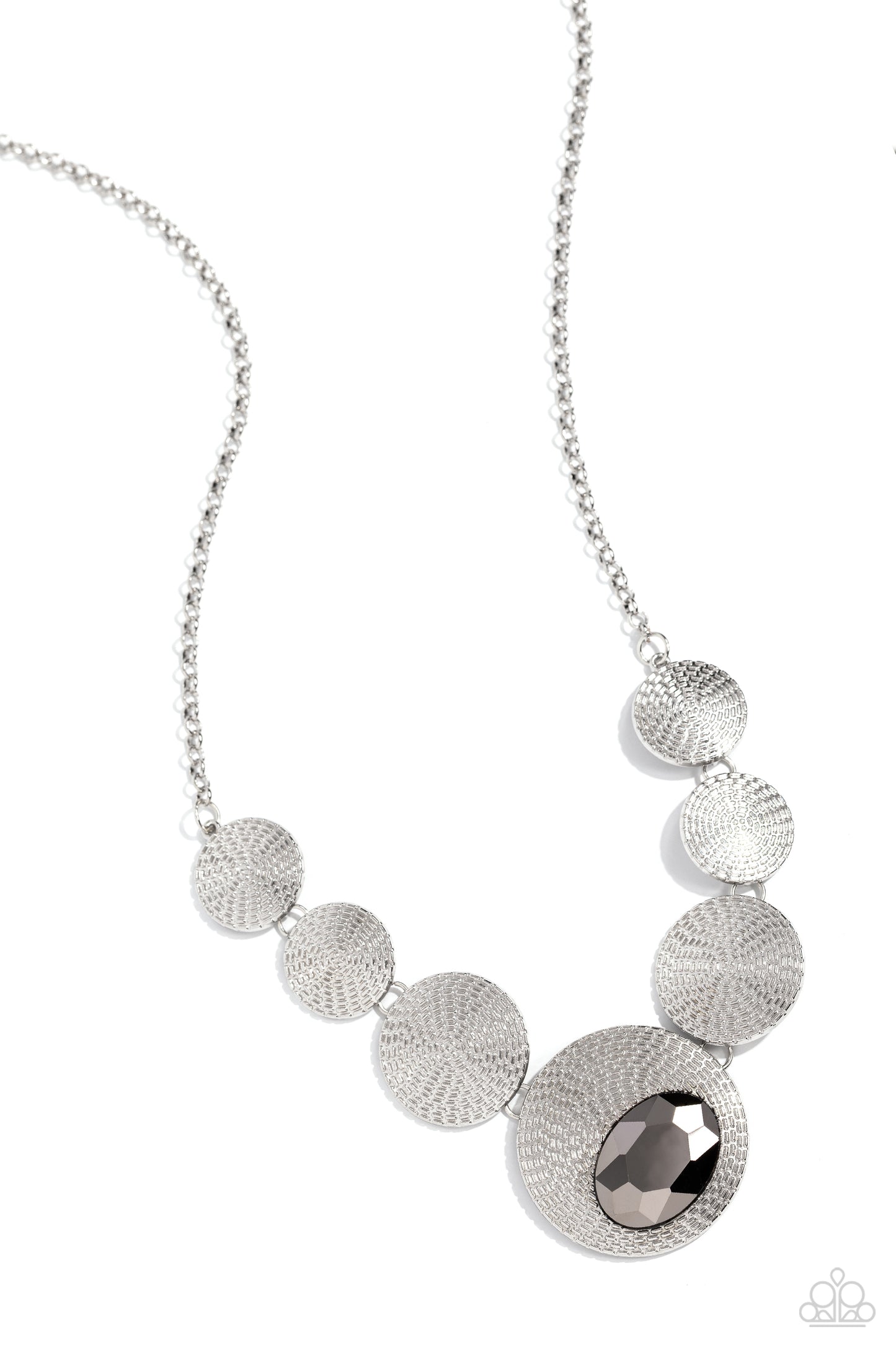 Paparazzi Accessories - EDGY or Not - Silver Necklaces embossed in an elongated dotted motif, a rustic collection of silver discs in varying sizes ruggedly links below the collar for an artisan inspired fashion. A faceted, oval, hematite gem sits at an angle on the biggest disc for a dauntless pop of color against the neckline. Features an adjustable clasp closure. Featured inside The Preview at Made for More! Sold as one individual necklace. Includes one pair of matching earrings.