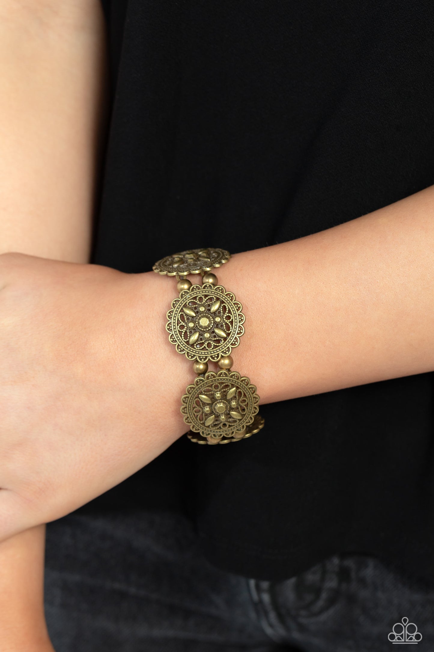 Paparazzi Accessories - Leave of Lace - Brass Bracelets filled with lace-like filigree, an antiqued collection of brass circular frames are delicately threaded along stretchy bands around the wrist for a whimsically vintage look. High-sheen brass beads separate each floral filigree disc for additional monochromatic glow. Sold as one individual bracelet.