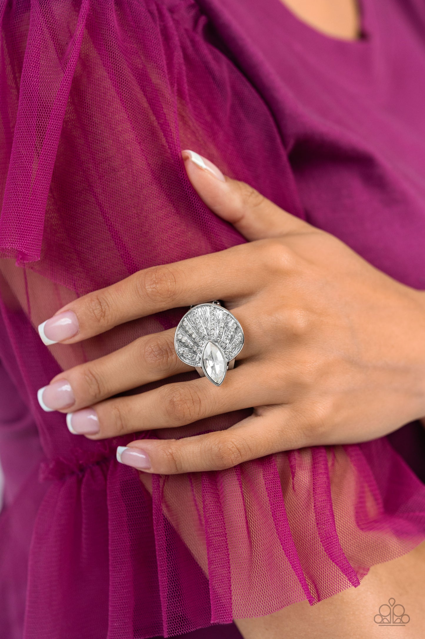 Paparazzi Accessories - Fan Dance Dazzle - White Ring an asymmetrical silver disc, featuring linear layers of dainty white rhinestones against a textured backdrop, reflect light off its every angle from airy silver bands. A marquise-cut white gem interrupts the fan-like pendant, creating additional shine to the glitzy display. Features a stretchy band for a flexible fit. Sold as one individual ring.