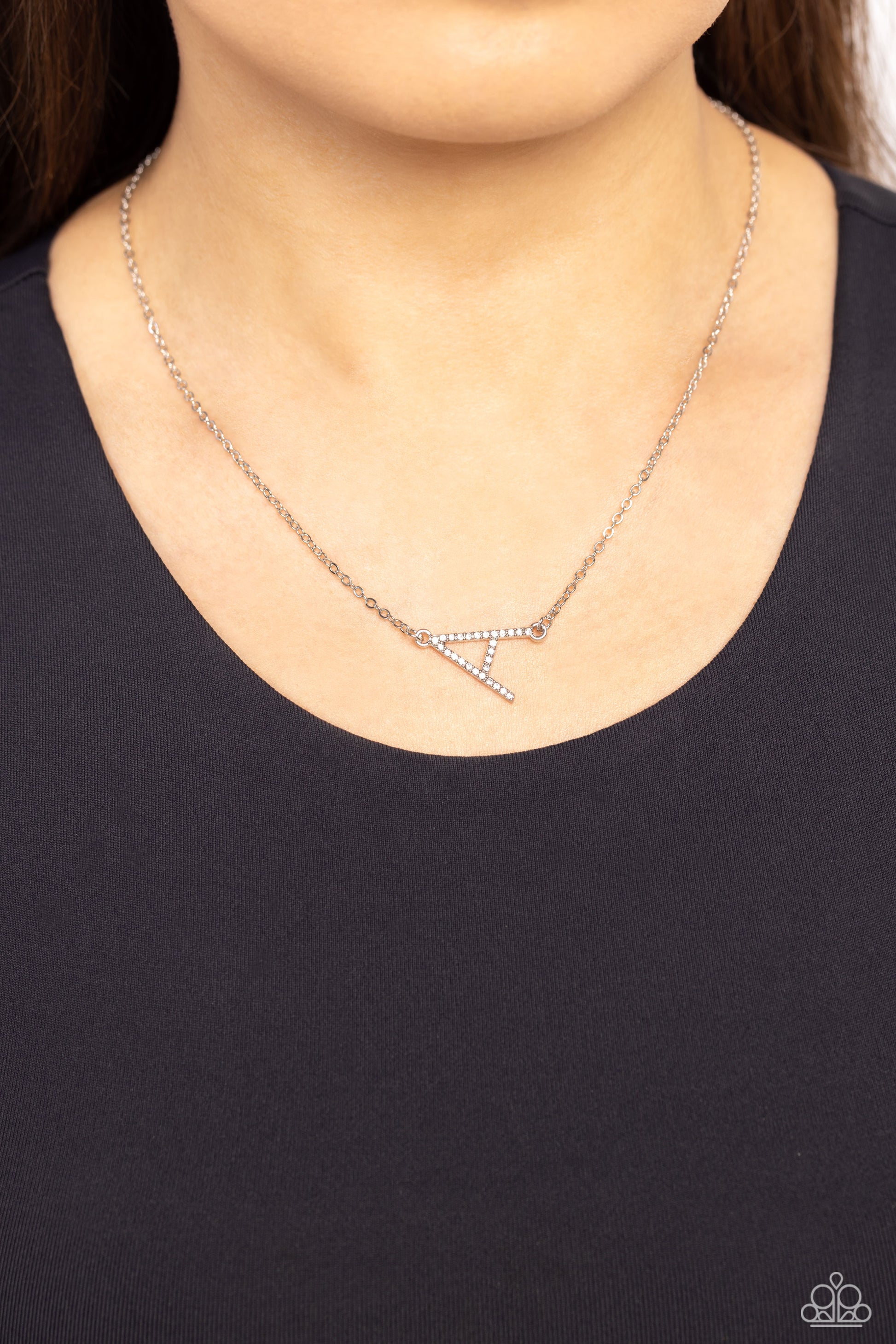 Embossed with dainty white rhinestones, a silver letter "A" hovers below the collar from a dainty silver chain, for a sentimentally simple design. Features an adjustable clasp closure.  Sold as one individual necklace. Includes one pair of matching earrings.
