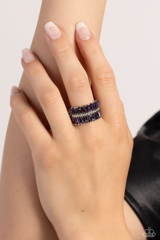 Paparazzi Accessories - Staggering Stacks - Purple Rings staggered rows of emerald-cut purple rhinestones flare out from the top and bottom of a row of classic white rhinestones, creating a smoldering statement piece atop the finger. Features a stretchy band for a flexible fit. Sold as one individual ring.