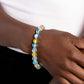 Paparazzi Accessories - Clear Craze - Blue Bracelets infused with silver floral beads, a glassy collection of reflective blue and yellow-colored stone beads are threaded along an elastic stretchy band around the wrist for an adventurous pop of urban color.  Sold as one individual bracelet.