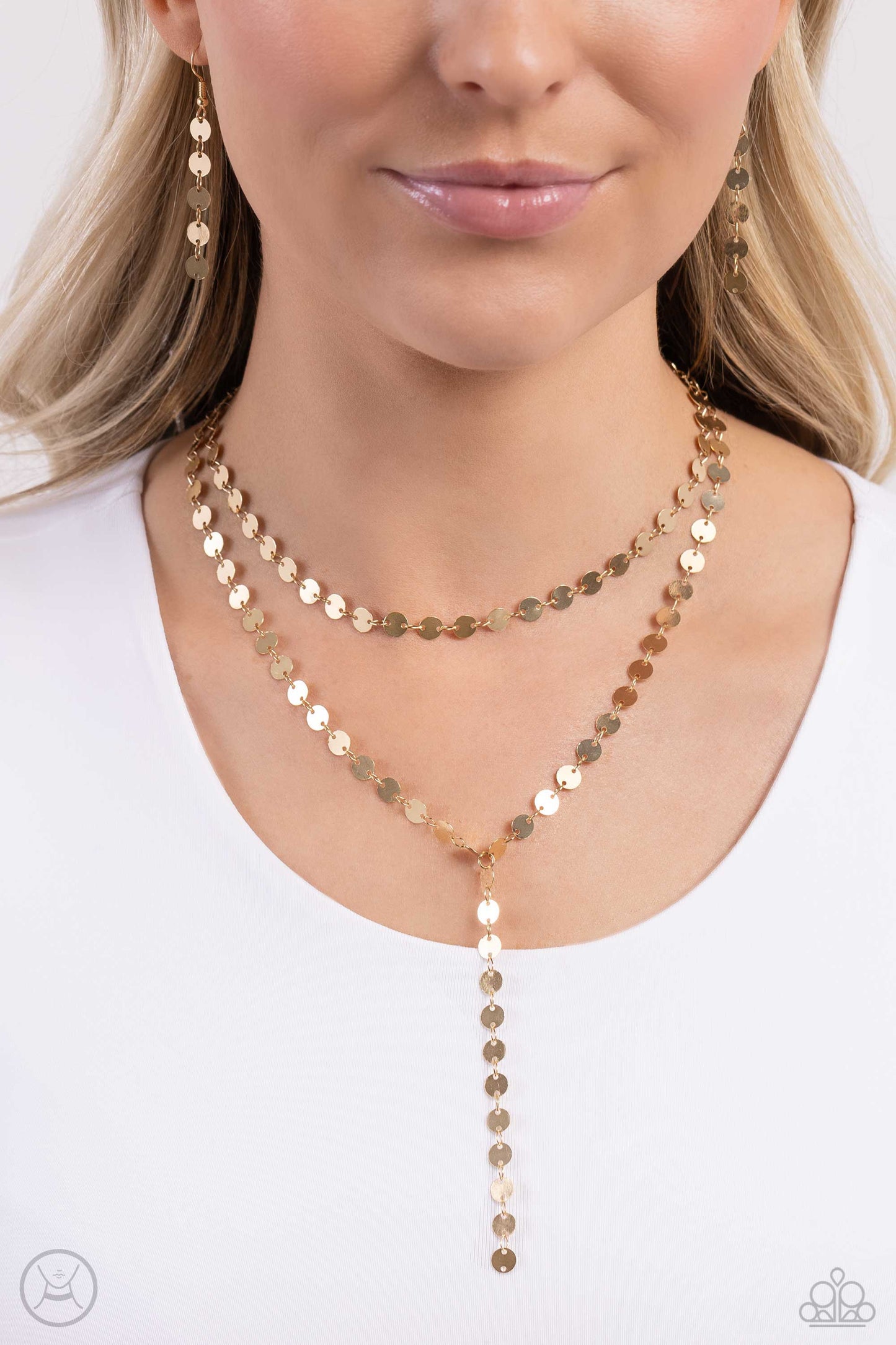 Paparazzi Accessories - Reeling in Radiance - Gold Necklaces high-sheen gold discs trickle around the collar and down the chest, creating an edgy lariat-styled fringe that sways and shimmers. Features an adjustable clasp closure. Sold as one individual choker necklace. Includes one pair of matching earrings.