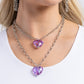 Paparazzi Accessories - Layered Love - Purple Heart Necklaces featuring a subtle iridescent shimmer, two glassy purple gem hearts are delicately suspended above one another on a paperclip and silver oval link chain for a whimsical double-stacked display. Features an adjustable clasp closure.  Sold as one individual necklace. Includes one pair of matching earrings.