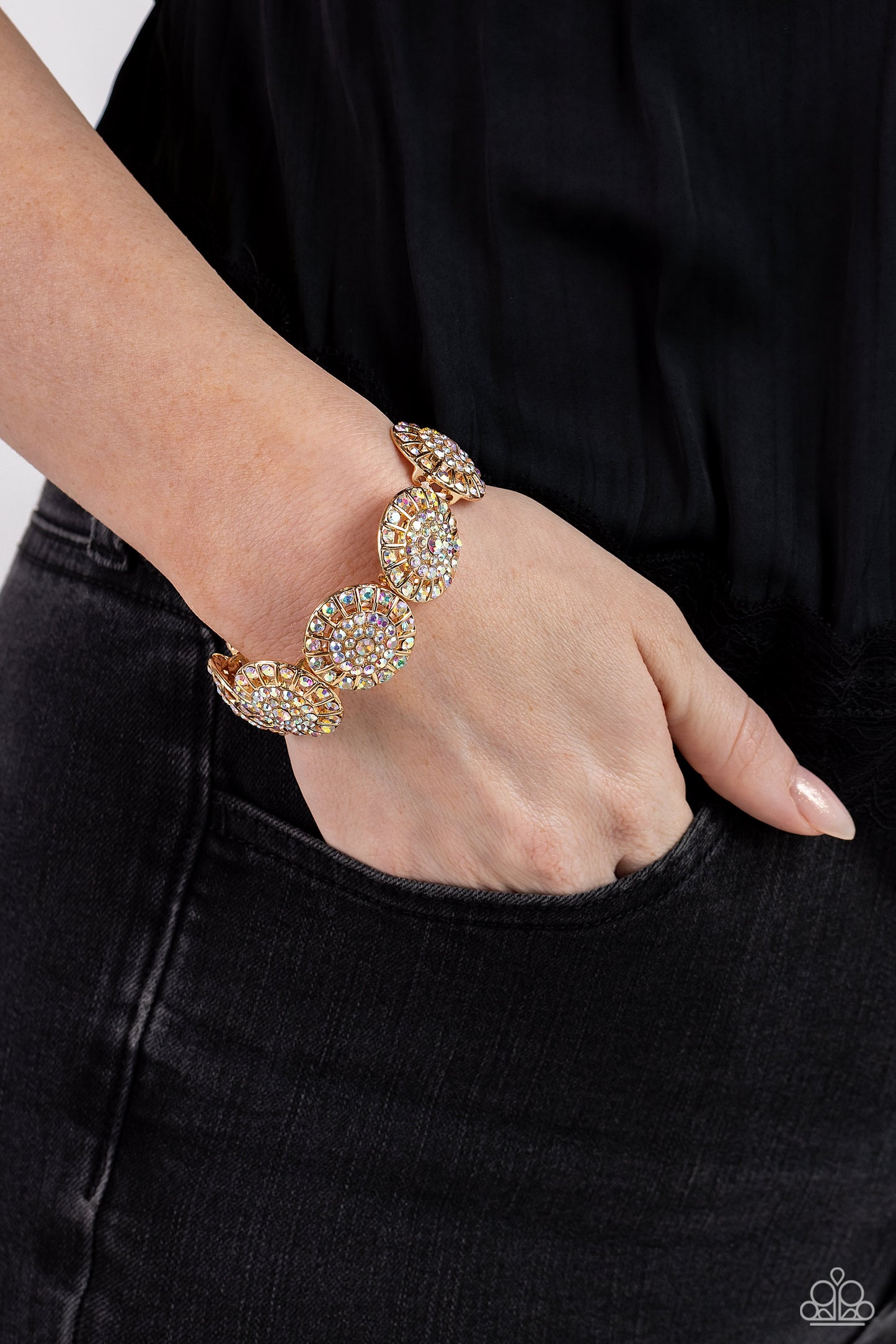 Paparazzi Accessories - Executive Elegance - Multi Bracelets featuring a wheel motif, concaved gold discs embossed in an explosion of iridescent rhinestones slide along a stretchy band around the wrist for a hint of dazzling refinement. Due to its prismatic palette, color may vary. Sold as one individual bracelet.