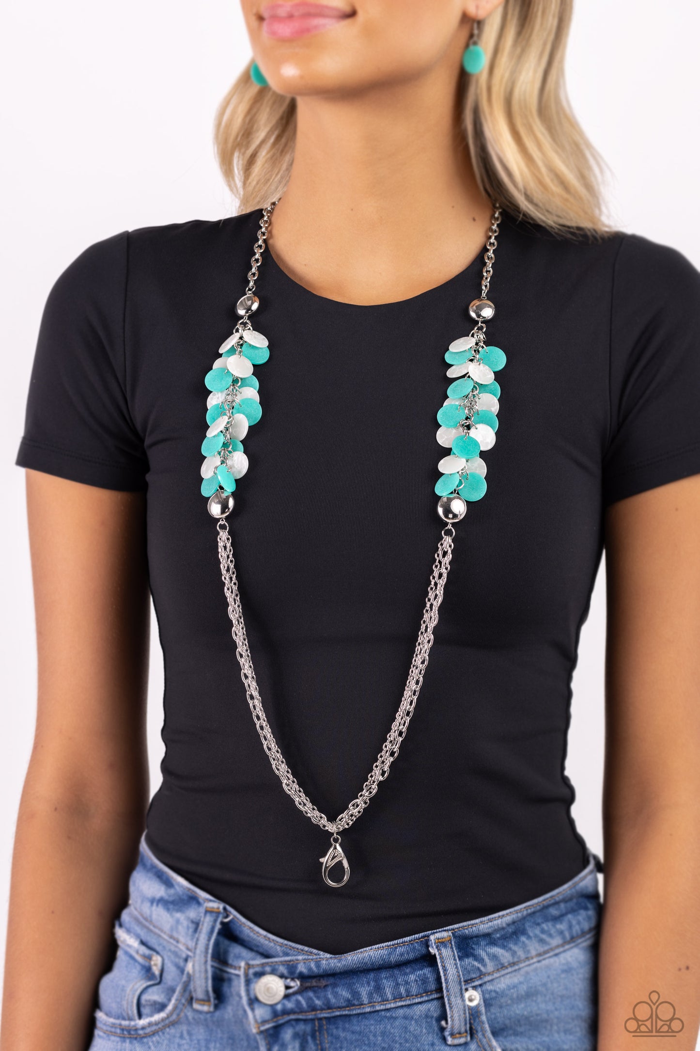 Paparazzi Accessories - Shell Sensation - Green Necklaces flared between two oversized silver beads, a collection of turquoise and white shell-like beads give way to sections of silver chains that connect across the chest for a colorful summery look. A lobster clasp hangs from the bottom of the elongated design to allow a name badge or other item to be attached. Features an adjustable clasp closure. Sold as one individual lanyard. Includes one pair of matching earrings.