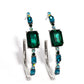 Paparazzi Accessories - Elite Ensemble - Green Hoop Earringgeencrusted in round and emerald-cut aquamarine and emerald gems, some featuring an iridescent sheen, an exaggerated oblong silver hoop curls around the ear, refracting light in a dramatic, knockout finish. Earring attaches to a standard post fitting. Hoop measures approximately 2" long. Due to its prismatic palette, color may vary.  Sold as one pair of hoop earrings.