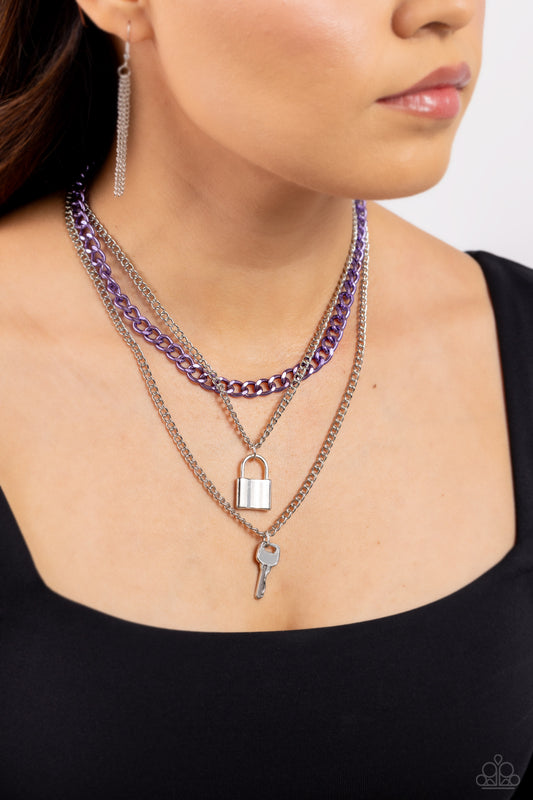 Paparazzi Accessories - Locked Labor - Purple Necklaces a sleek silver lock and silver key trickle from the bottoms of glistening silver chains down the chest, creating industrial layers. A purple curb chain hangs above the pendants for a touch of colorfully gritty sheen. Features an adjustable clasp closure.  Sold as one individual necklace. Includes one pair of matching earrings.