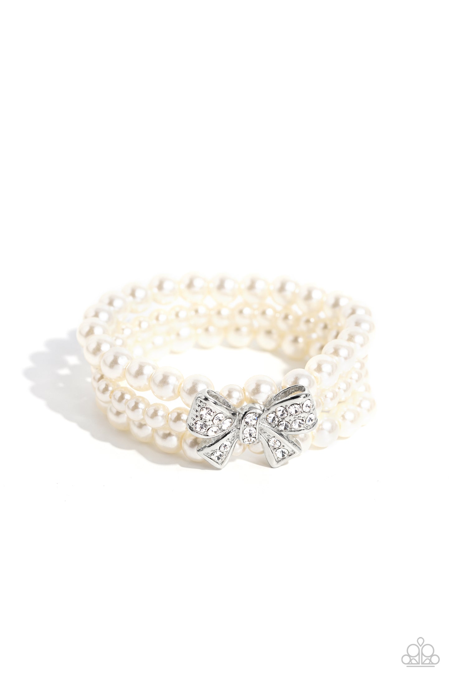 Paparazzi Accessories - How Do You Do? - White Pearl Bracelet strung along elastic stretchy bands, three strands of high-sheen classic white pearls wrap around the wrist. Featured atop the pearly collection, a loopy silver bow, filled with glistening white rhinestones is attached to the center of the wrist for a dramatically dazzling finish. Sold as one individual bracelet.
