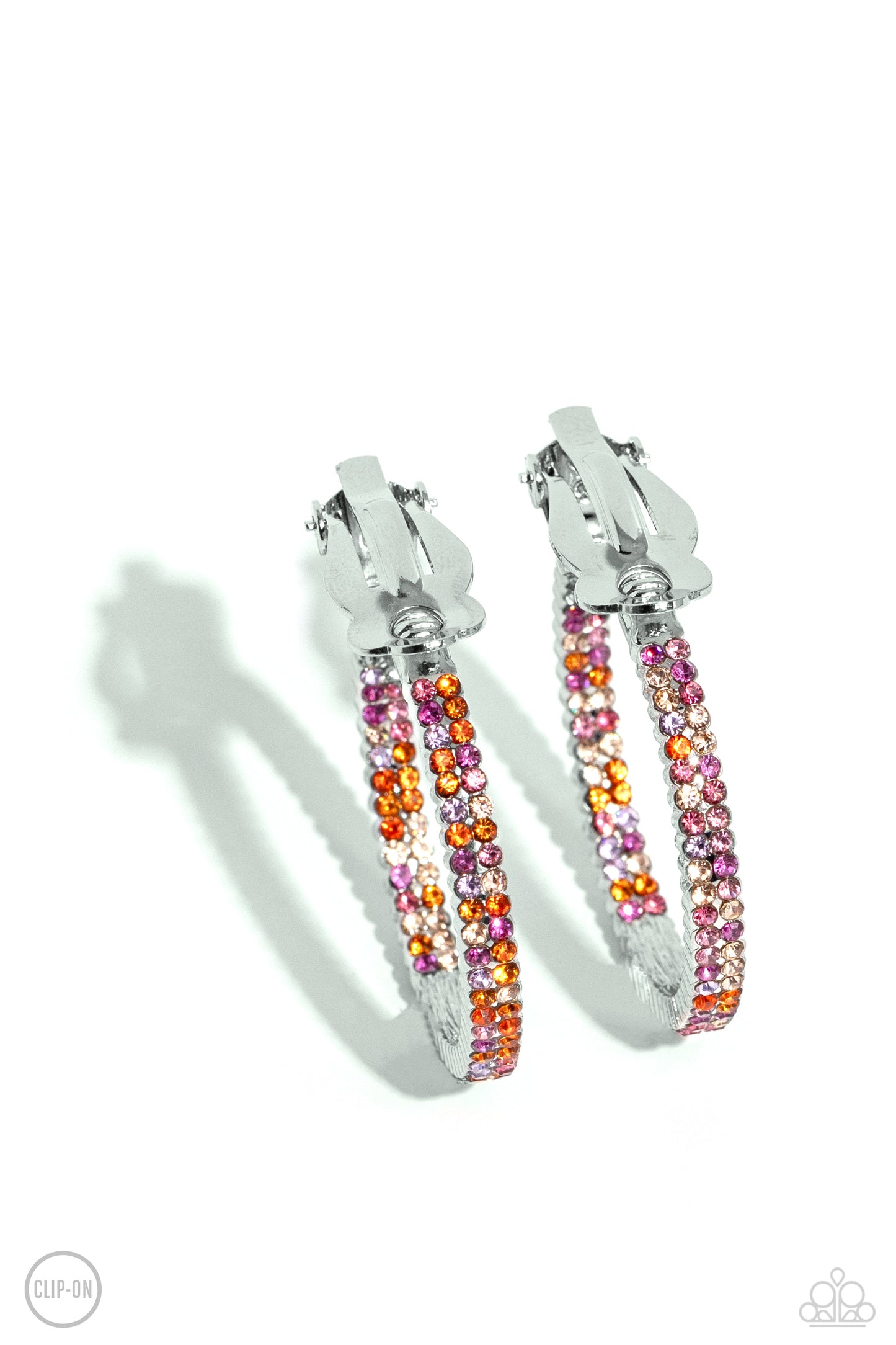 Paparazzi Accessories - Outstanding Ombre' - Orange Clip-On Earrings the front half and lower inner curve of a textured silver hoop are encrusted in dazzling ombré shades of orange, pink, and purple for a flawless look. Earring attaches to a standard clip-on fitting. Hoop measures approximately 1" in diameter. Sold as one pair of clip-on earrings.