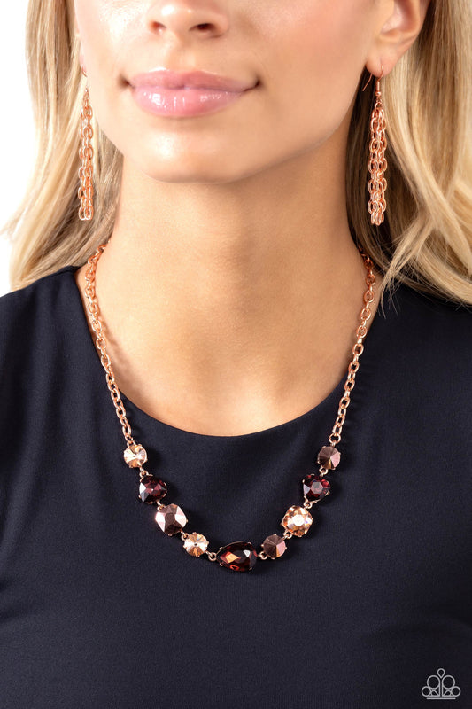 Paparazzi Accessories - Emphatic Edge - Copper Necgeometrset in shiny copper-pronged fittings, glittering geometric copper aurum, topaz, and peachy gem and acrylic shapes delicately coalesce around the collar on a sleek shiny copper chain for an edgy statement. Features an adjustable clasp closure.  Sold as one individual necklace. Includes one pair of matching earrings.  Order date 11/1/23