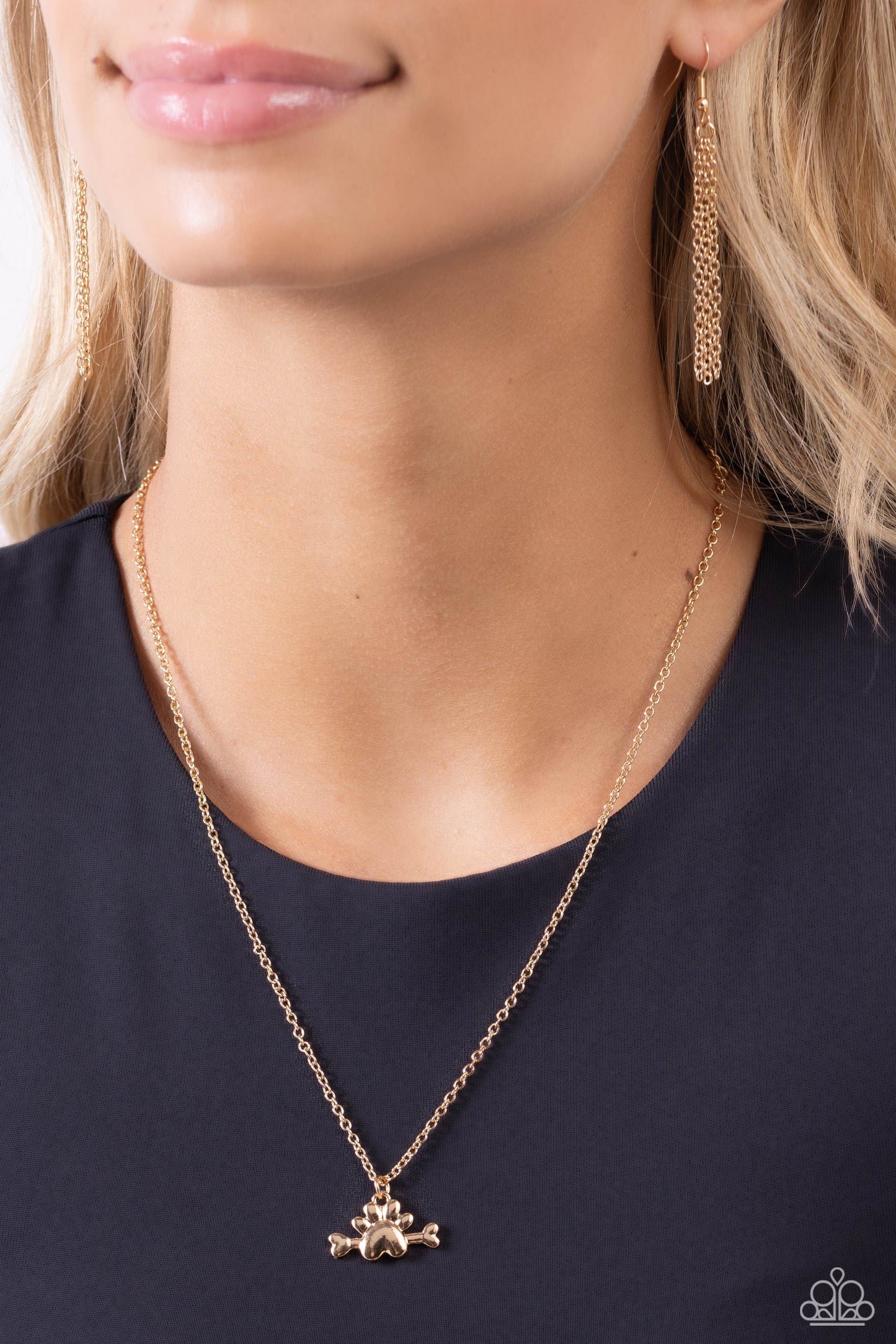 Paparazzi Accessories - Loyal Companion - Gold Necklaces infused through a sleek gold dog bone, a shiny gold paw print charm swings from a classic gold chain below the collar, creating a pet-lover inspired pendant. Features an adjustable clasp closure. Sold as one individual necklace. Includes one pair of matching earrings.