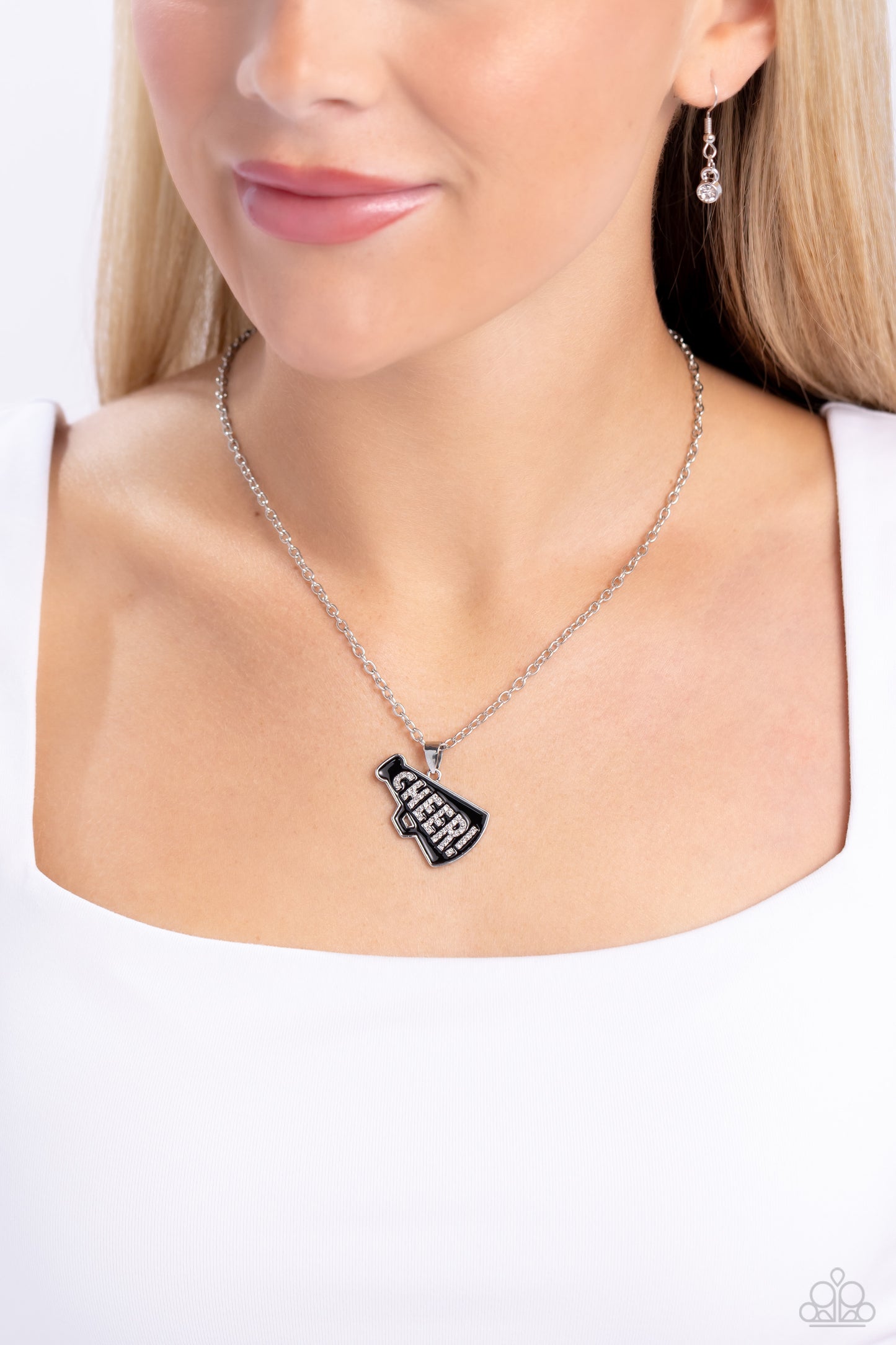 Paparazzi Accessories - Cheer Champion - Black Necklaces outlined in glistening white rhinestones, the word "Cheer!" is embossed in the center of a black-painted megaphone pendant along a dainty silver chain for a sports-inspired statement. Features an adjustable clasp closure. Sold as one individual necklace. Includes one pair of matching earrings.