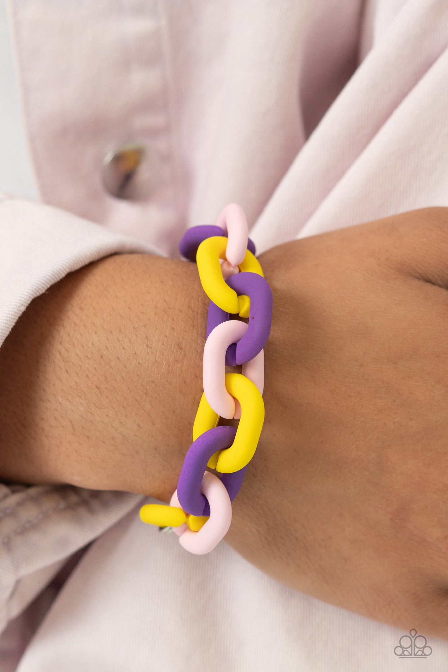Paparazzi Accessories - Speed Smile - Purple Jewelry Sets two strands of silver chain give way to a strand of oversized purple, baby pink, and yellow acrylic links for a colorful statement. A purple-painted smiley face pendant, with a lightning bolt for one eye, cascades from the colorful links for an exaggerated touch of personality. Features an adjustable clasp closure.