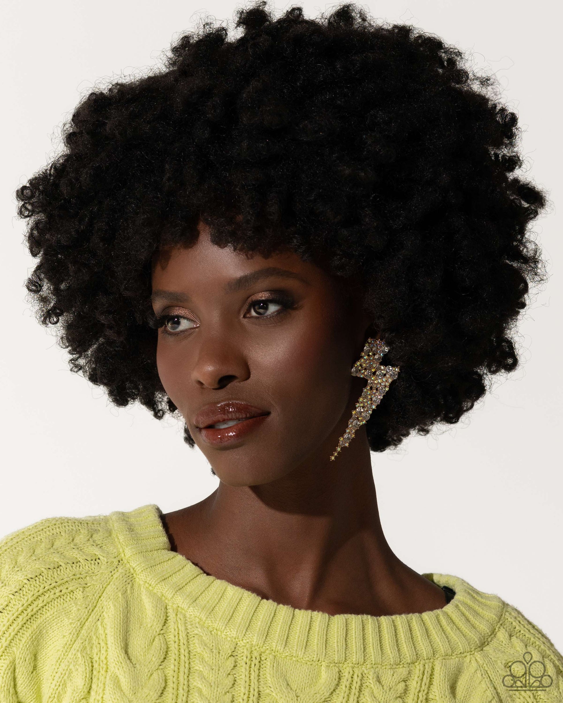 Paparazzi Accessories - Electric Effulgence - Gold Earrings featuring white gems and iridescent rhinestones, a pair of airy gold lightning bolts flicker and flash along the ear for a dazzling design. Earring attaches to a standard post fitting. Due to its prismatic palette, color may vary.  Sold as one pair of post earrings.