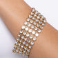 Paparazzi Accessories - GLASSY Gallery - Gold Bracelets suspended from sleek, dainty gold bars, five linked rows of glassy white rhinestones stack into a blinding display around the wrist for a jaw-dropping look. Features an adjustable clasp closure.  Sold as one individual bracelet.