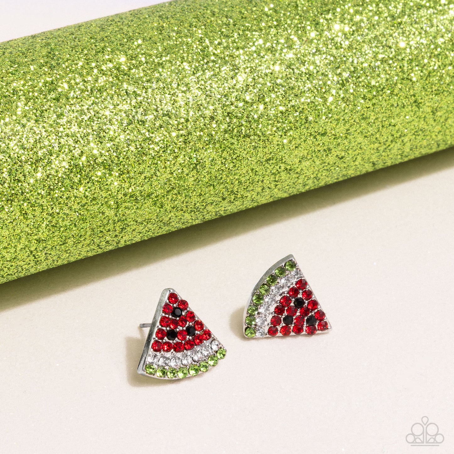 <p>Paparazzi Accessories - Watermelon Slice - Red Earrings featuring red, black, white, and green rhinestones, a silver watermelon-inspired post glitters from the ear for a fresh, fruity design. Earring attaches to a standard post fitting.</p> <p><i>Sold as one pair of post earrings.</i></p>