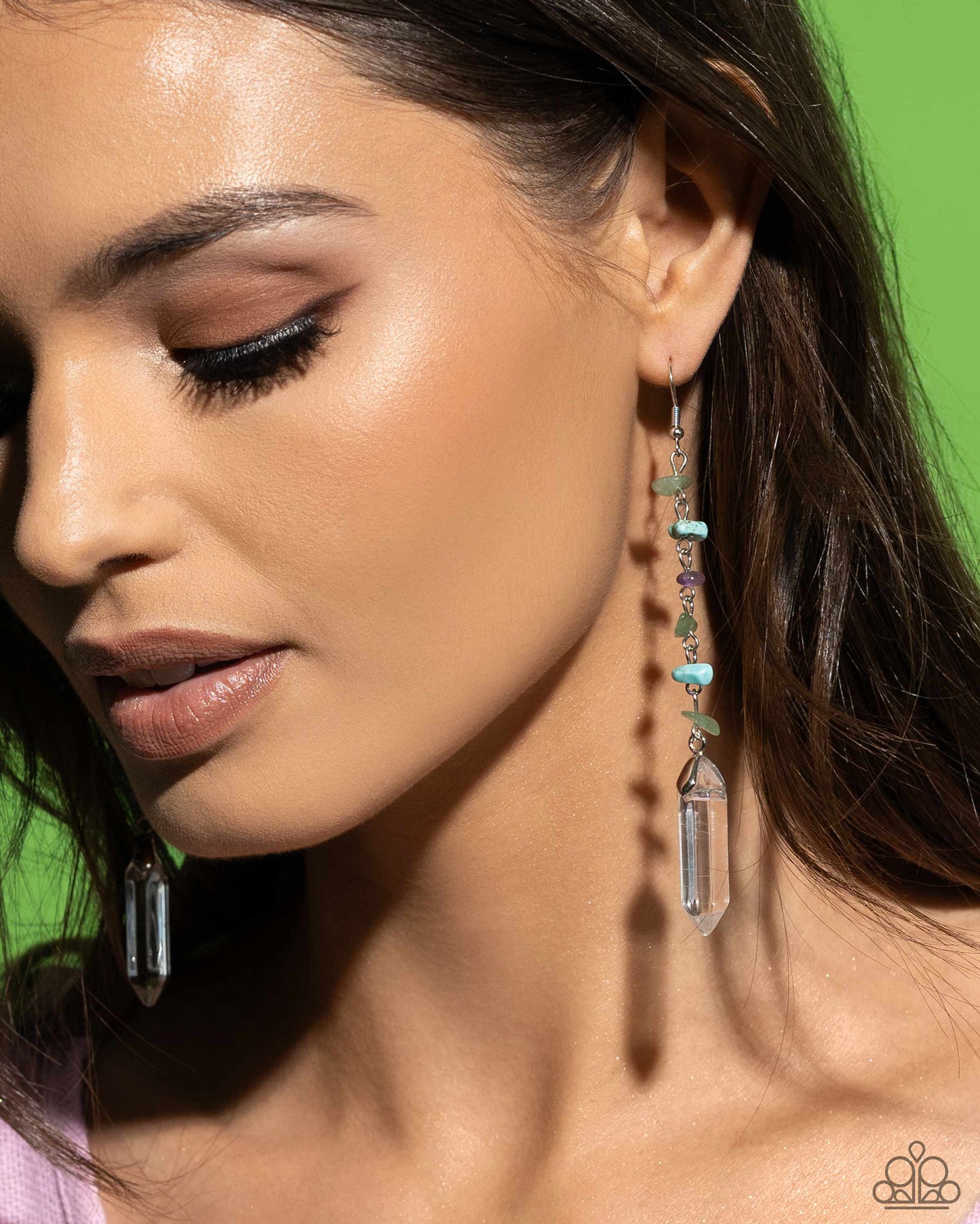Paparazzi Accessories - Quartz Qualification - Green Earrings chiseled jade, turquoise, and amethyst stones connect down the ear along a silver chain, leading the eye to a clear quartz-like piece at its end for an elegantly earthy lure. Earring attaches to a standard fishhook fitting. As the stone elements in this piece are natural, some color variation is normal. Sold as one pair of earrings.