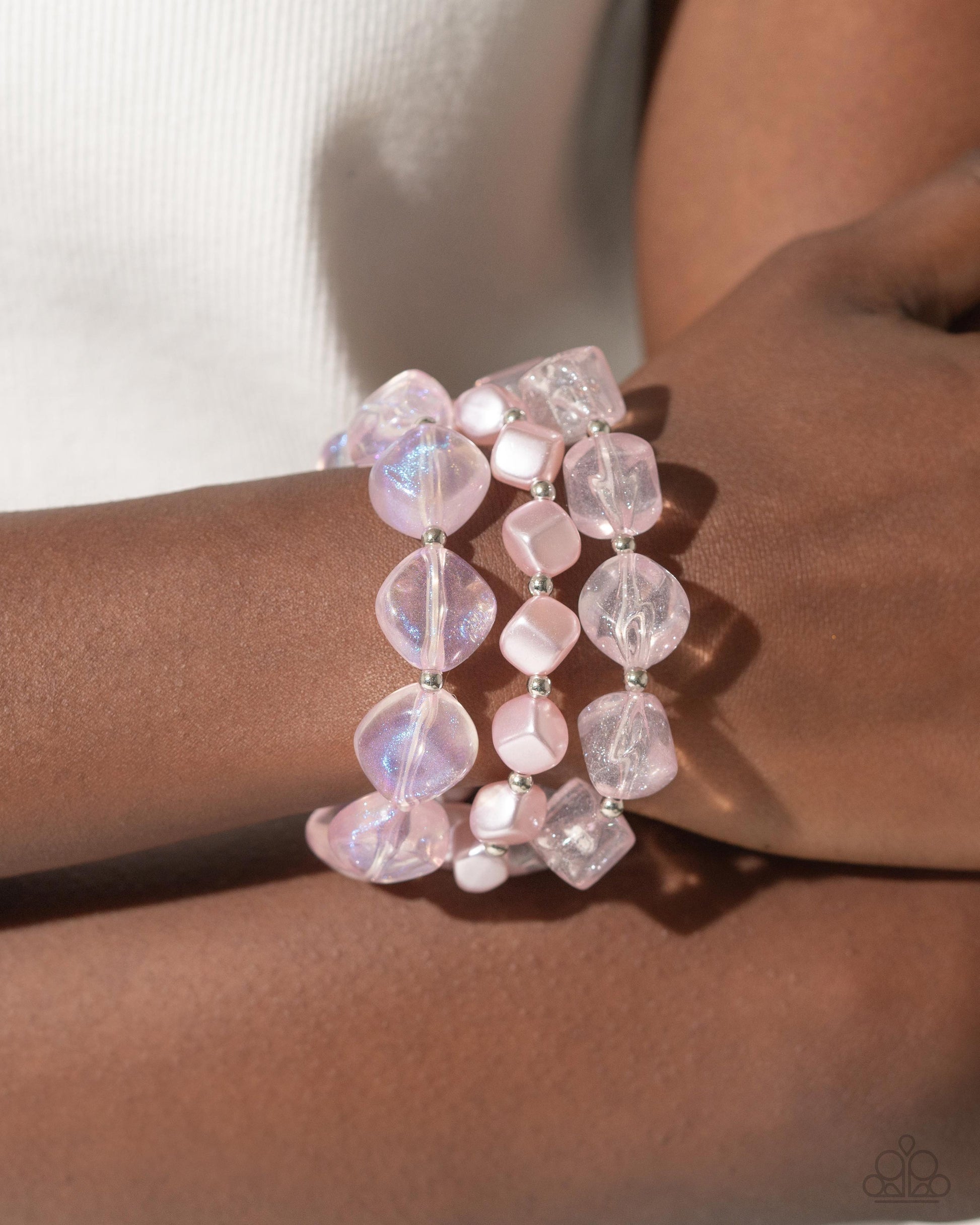 Paparazzi Accessories - Cubed Cameo - Pink Jewelry Sets cubed baby pink pearls join a strand of baby pink clear acrylics that alternate with silver discs and a silver fitting around the neckline. A third strand joins the refined display featuring a silver abstract chain that has dangling silver beads, baby pink pearls in a variety of shapes, and glittery clear acrylics for a classy display. Features an adjustable clasp closure. Sold as one individual necklace. Includes one pair of matching earrings.