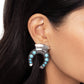 Embellished with turquoise stones and silver-studded details, an oversized antiqued silver horseshoe hangs upside down from a curved high-sheen silver accent. Additional high-sheen textured silver squares that come to a point, cap the ends of the horseshoe for additional eye-catching color. Earring attaches to a standard clip-on fitting. As the stone elements in this piece are natural, some color variation is normal.  Sold as one pair of clip-on earrings.