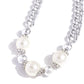 Oversized, high-sheen silver curb chain links gives way to a collection of oversized white pearls, silver beads, and white rhinestone-encrusted silver rings for a glamorously glossy look. Features an adjustable clasp closure.  Sold as one individual necklace. Includes one pair of matching earrings.
