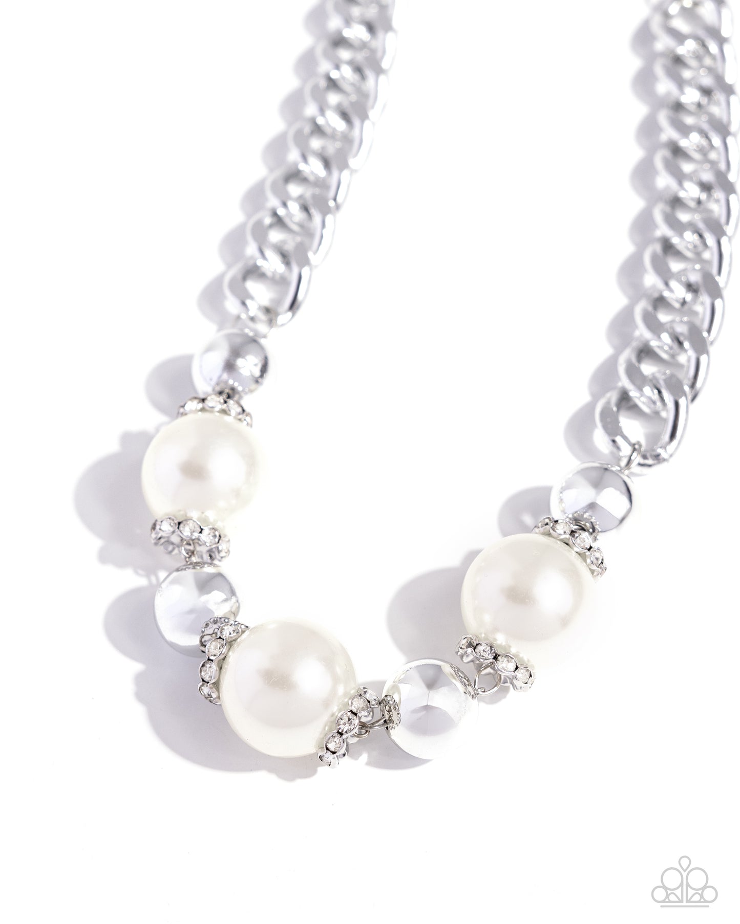 Oversized, high-sheen silver curb chain links gives way to a collection of oversized white pearls, silver beads, and white rhinestone-encrusted silver rings for a glamorously glossy look. Features an adjustable clasp closure.  Sold as one individual necklace. Includes one pair of matching earrings.