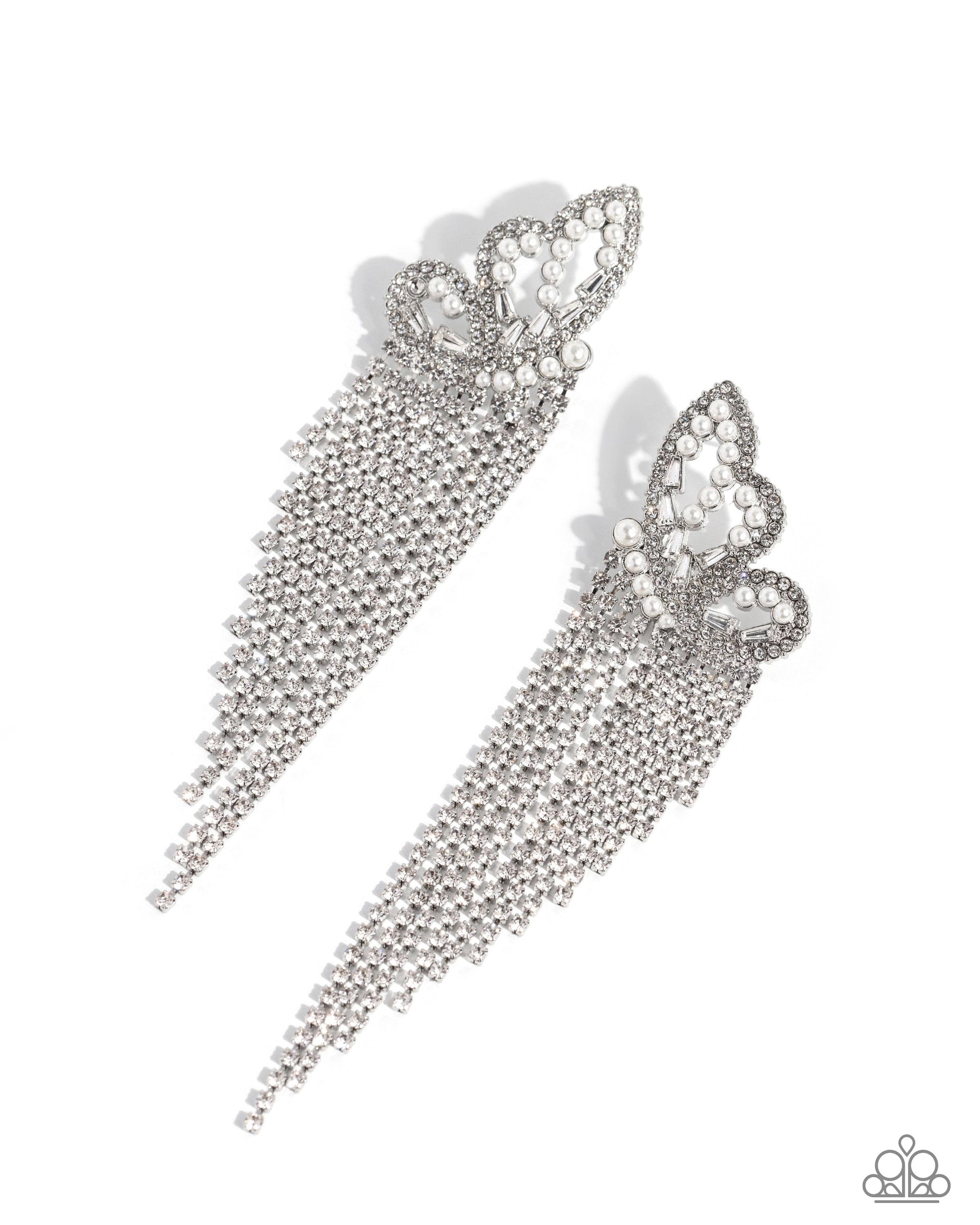 <p>Paparazzi Accessories - Aerial Accent - White Earrings glassy white rhinestones, dainty white pearls, and white emerald-cut gems are encrusted along the front of an airy silver butterfly frame, creating a whimsical centerpiece. Staggered rows of white rhinestones pressed in delicate silver square fittings cascade from the sparkly centerpiece, seemingly lifting the butterfly off to its glitzy flight. Earring attaches to a standard post fitting.</p> <p><i>Sold as one pair of post earrings.</i></p>