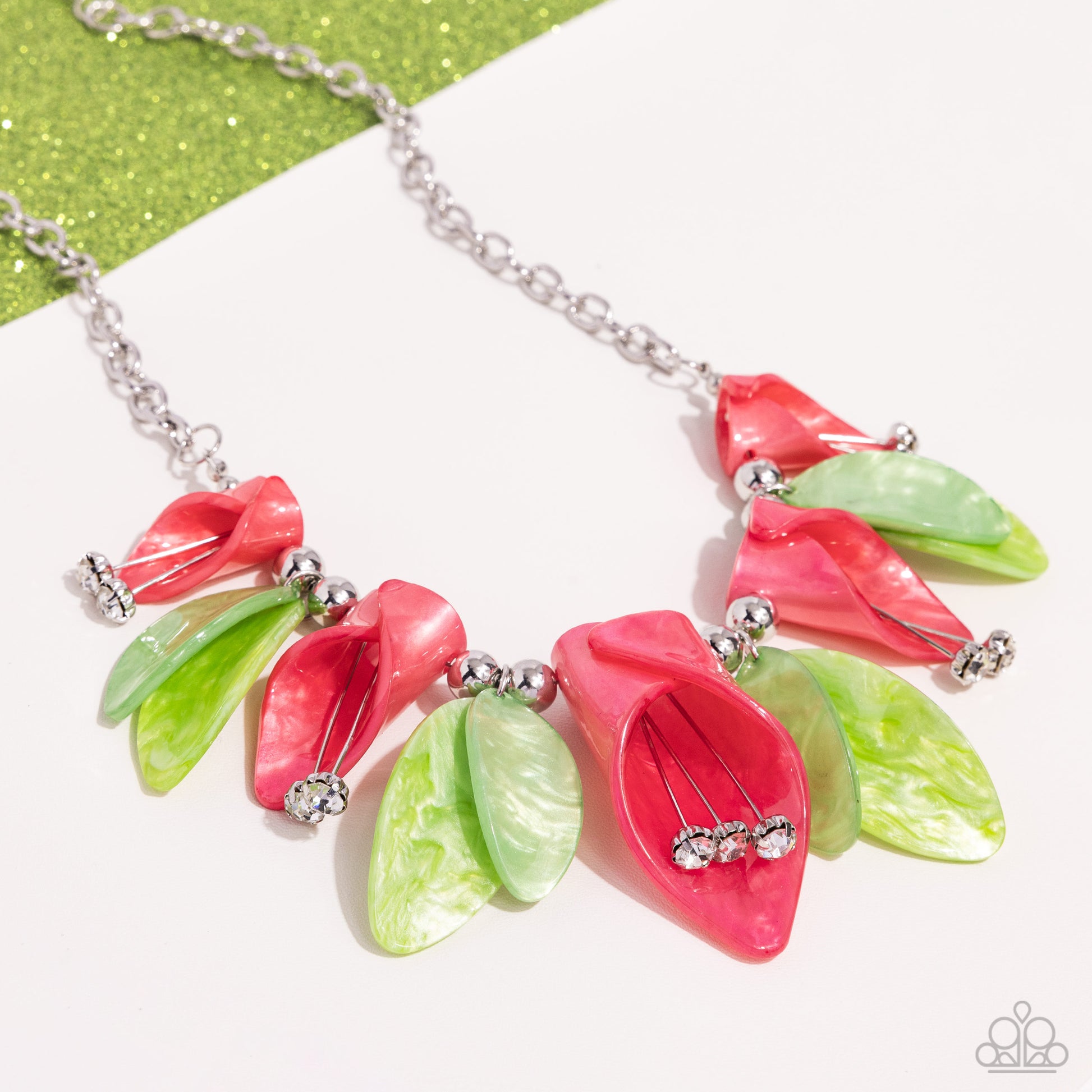 Bright coral acrylics, curl into tulip-like flowers while green acrylics, featuring a reflective shimmer, layer into leaves that alternate with the coral tulips. White gems bloom from dainty silver wires, forming into pistils from the coral tulips while glossy duos of silver beads frame the green leaves for additional sheen. Features an adjustable clasp closure.  Sold as one individual necklace. Includes one pair of matching earrings.