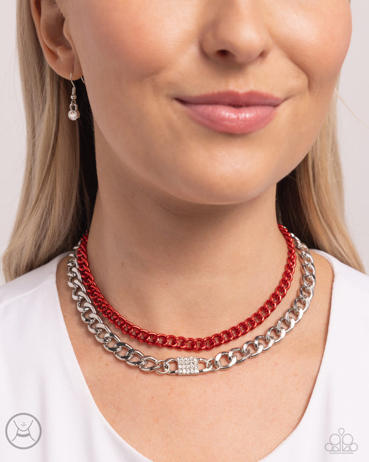 Dipped in an electric red hue, a classic chain joins a dramatic silver curb chain, layering below the collar in a fierce fashion. White rhinestones adorn the surface of a square pendant that is centered in the glistening silver curb chain, adding a timeless shimmer to the show-stopping piece. Features an adjustable clasp closure.  Sold as one individual choker necklace. Includes one pair of matching earrings.