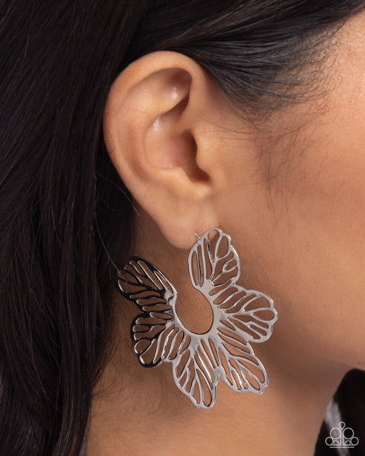 Paparazzi Accessories - Floral Fame - Silver Earrings airy, high-sheen silver flowers bloom and flare around the ear for a whimsical display. Earring attaches to a standard post fitting. Hoop measures approximately 2 1/4" in diameter.  Sold as one pair of hoop earrings.