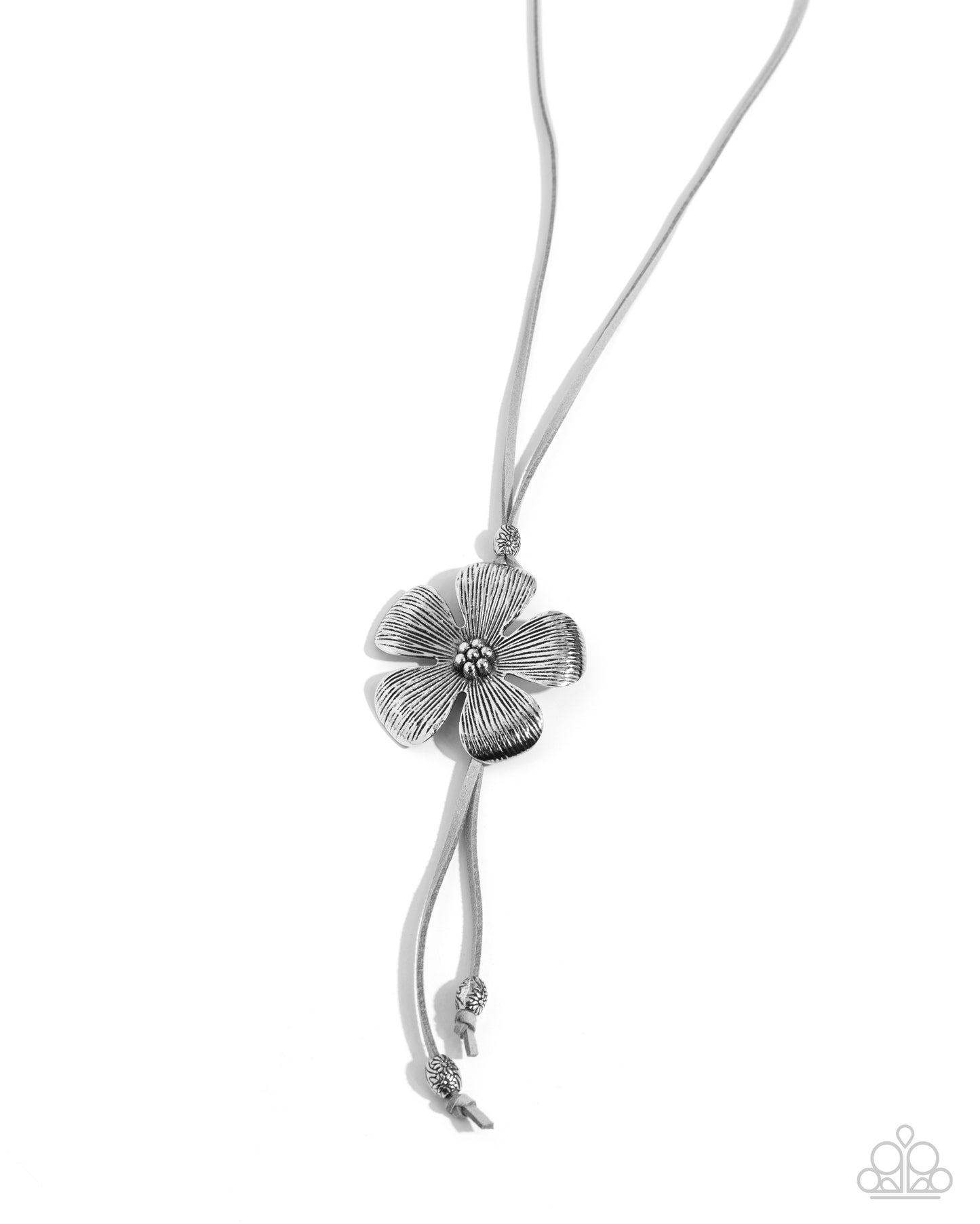 Featuring a mini-beaded floral center, a textured silver flower glides along a gray cord around the neckline creating an adjustable pendant. Highly-embellished silver floral oval beads cap the ends of the gray cording and rise above the solitaire flower for additional whimsy. Features a bolo closure. Sold as one individual necklace. Includes one pair of matching earrings.