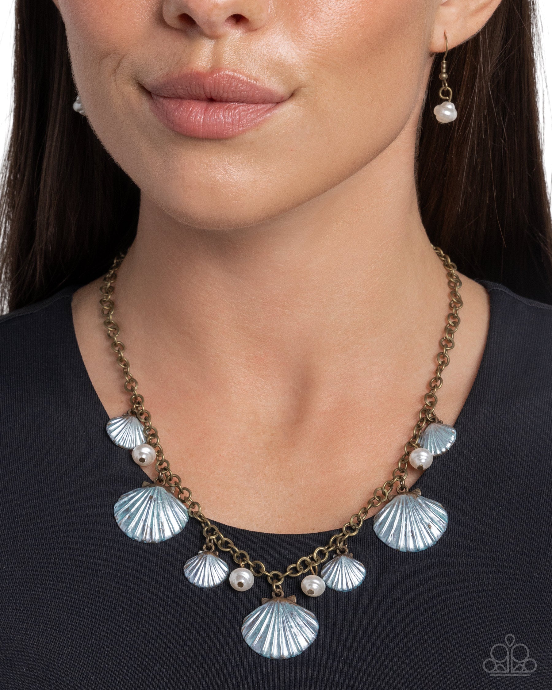 Featuring a mini-beaded floral center, a textured silver flower glides along a gray cord around the neckline creating an adjustable pendant. Highly-embellished silver floral oval beads cap the ends of the gray cording and rise above the solitaire flower for additional whimsy. Features a bolo closure.  Sold as one individual necklace. Includes one pair of matching earrings.