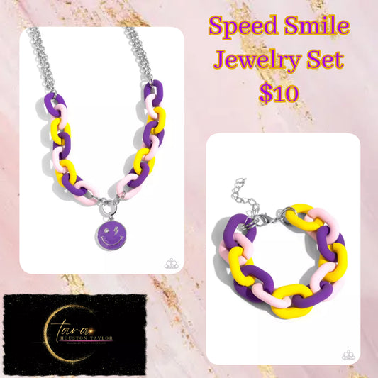 Paparazzi Accessories - Speed Smile - Purple Jewelry Sets two strands of silver chain give way to a strand of oversized purple, baby pink, and yellow acrylic links for a colorful statement. A purple-painted smiley face pendant, with a lightning bolt for one eye, cascades from the colorful links for an exaggerated touch of personality. Features an adjustable clasp closure.