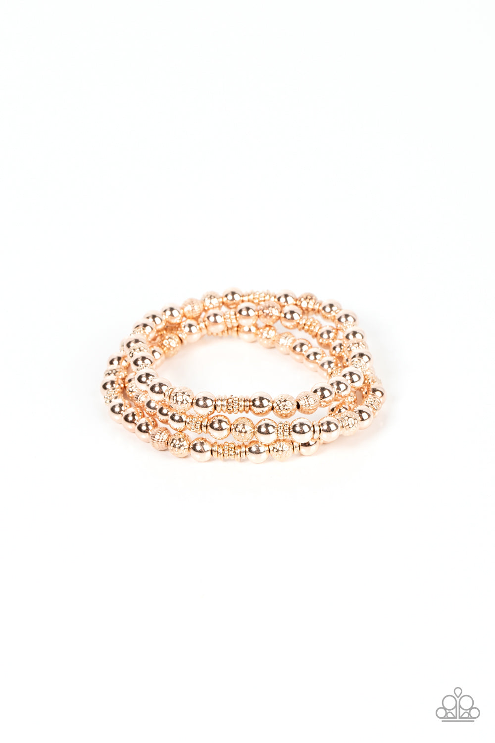 Paparazzi Accessories - Boundless Boundaries - Rose Gold Bracelets a shiny collection of smooth, studded, and textured rose gold beads are threaded along stretchy bands around the wrist, creating dainty layers. Sold as one set of three bracelets.