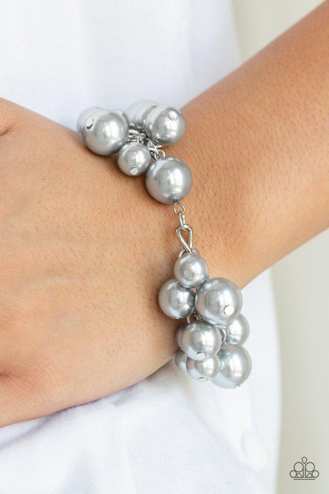 Clusters of classic and oversized silver pearls swing from a pearl beaded silver chain, creating a fabulous fringe. Features an adjustable clasp closure. Sold as one individual bracelet. Paparazzi Jewelry is lead and nickel free so it's perfect for sensitive skin too!