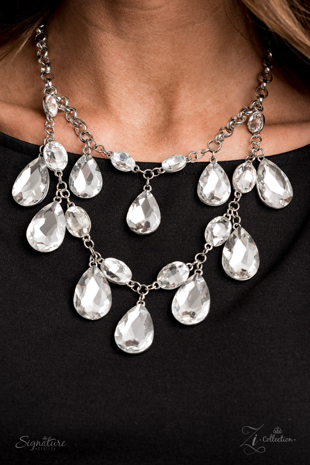 Paparazzi Accessories The Sarah - Zi Collection Necklaces tiers of oversized white teardrop gems demand attention as they drip from two blinding rows of elegantly linked white oval rhinestones. Infused with sections of chunky silver chain links, the sparkling rows brilliantly layer below the collar, becoming the center of every conversation. Features an adjustable clasp closure.