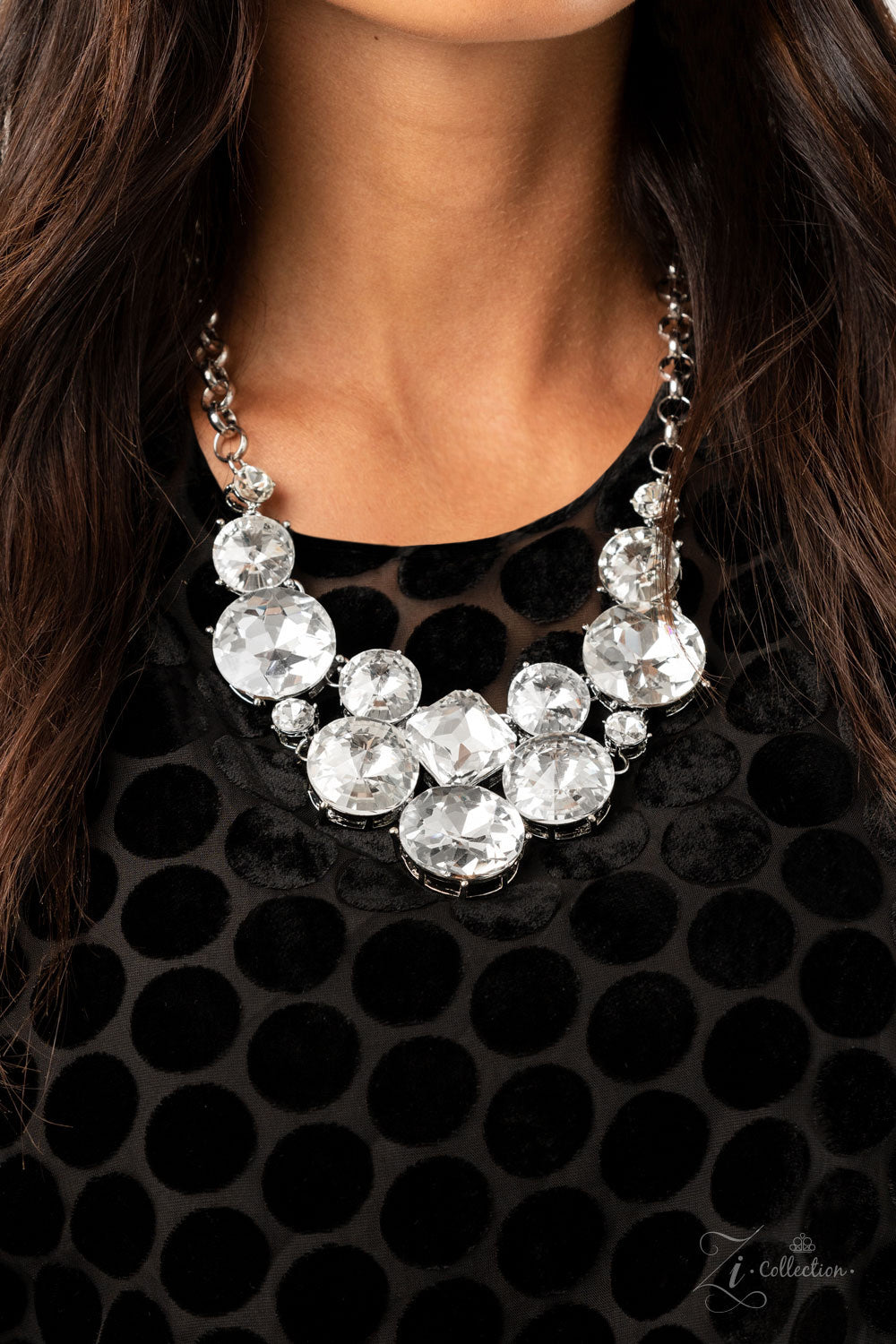 Paparazzi Accessories Unpredictable - 2020 Zi Collection Necklaces varying in size and shape, a dramatic collision of oversized white rhinestones connect into an unapologetically glamorous statement piece below the collar. Attached to chunky silver links, the breathtaking display of clustered gems radiates confidence. Features an adjustable clasp closure.  Sold as one individual necklace. Includes one pair of matching earrings.