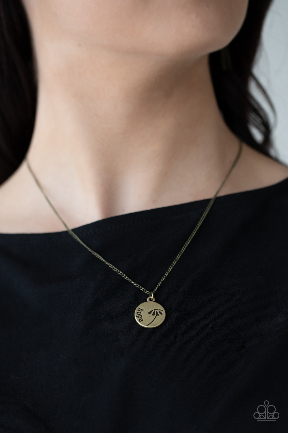 Hold On To Hope - Brass Inspirational Necklaces stamped in a whimsical flower, a dainty brass disc is stamped in the word, "Hope," creating an inspirational pendant below the collar. Features an adjustable clasp closure. Sold as one individual necklace. Includes one pair of matching earrings. Paparazzi Jewelry is lead and nickel free so it's perfect for sensitive skin too!