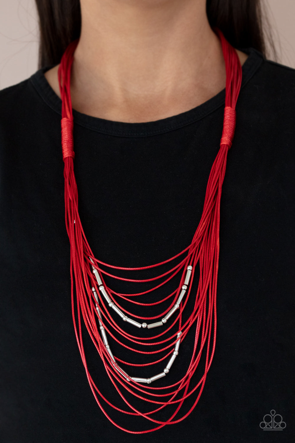 Paparazzi Accessories - Nice CORD-ination - Red Necklaces two rows of dainty silver beads and cylindrical rods are threaded along strands of shiny red cording that has been knotted in place, creating edgy rows across the chest. Features a magnetic closure.  Sold as one individual necklace. Includes one pair of matching earrings.
