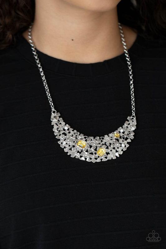 Paparazzi Accessories Fabulously Fragmented - Yellow Necklaces sporadically dotted in mismatched yellow and white rhinestones, a smattering of fragmented silver frames coalesce into a bold half moon below the collar for an edgy fashion. Features an adjustable clasp closure.  Sold as one individual necklace. Includes one pair of matching earrings.  Paparazzi Jewelry is lead and nickel free so it's perfect for sensitive skin too!