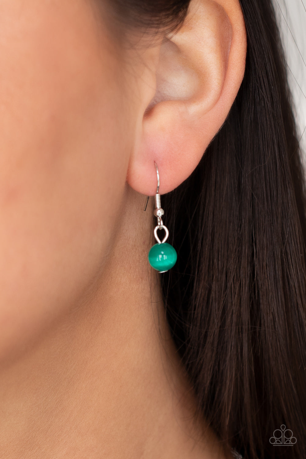 Warmhearted Glow - Green Necklaces oversized Mint cat's eye stone frame swings from the bottom of a lengthened silver chain, creating a flirtatious pendant. Features an adjustable clasp closure. Sold as one individual necklace. Includes one pair of matching earrings. Paparazzi Jewelry is lead and nickel free so it's perfect for sensitive skin too!
