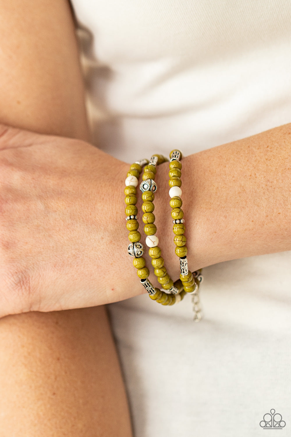 Paparazzi Accessories Desert Decorum - Green Stretchy Bracelets a xollection of Willow and white stone beads, silver cube beads, and ornate silver accents are threaded along invisible bands around the wrist, creating earthy layers. Features an adjustable clasp closure. Sold as one individual bracelet. Paparazzi Jewelry is lead and nickel free so it's perfect for sensitive skin too!