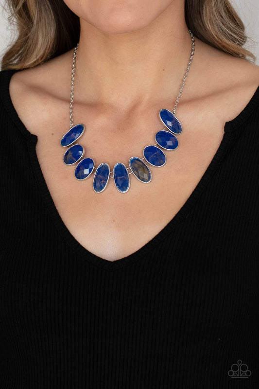 Elliptical Episode - Blue Glassy Necklaces generous bright blue glassy gems, dusted in shimmery gold, lay in silver oval frames and link across the collar creating a glimmering statement. Features an adjustable clasp closure.  Sold as one individual necklace. Includes one pair of matching earrings.  Paparazzi Jewelry is lead and nickel free so it's perfect for sensitive skin too!