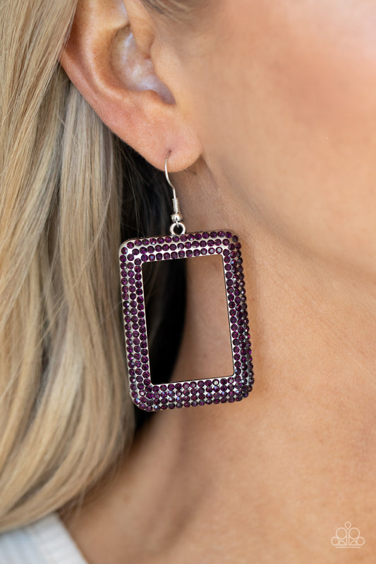 Paparazzi Accessories World FRAME-ous - Purple Fishhook Earrings bordered in rows of glittery purple rhinestones, an oversized silver rectangular frame swings from the ear for a fashionable finish. Earring attaches to a standard fishhook fitting.